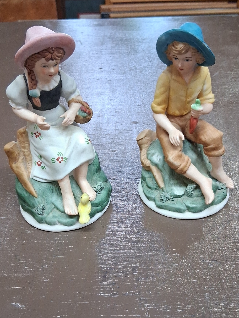 Porcelain figurines:‎ farmer child holding carrrots, farmer girl w/ apples pair